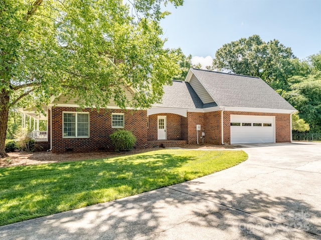 view of front of house featuring driveway, a garage, a front yard, brick siding, and roof with shingles