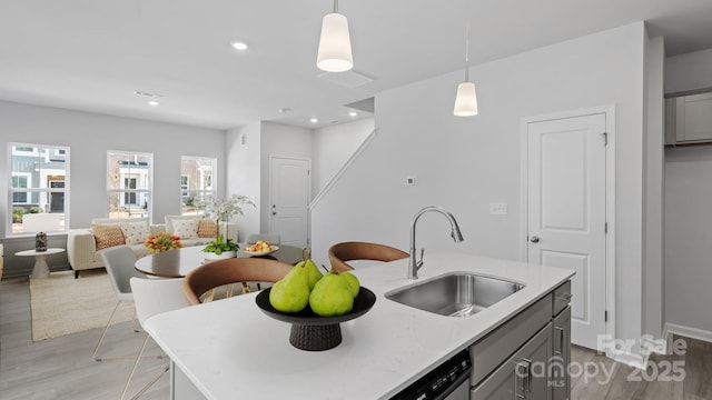 2906 Sloan Dr, Charlotte, NC 28208 - kitchen with a sink, light wood-style flooring, gray cabinetry, hanging light fixtures, and recessed lighting