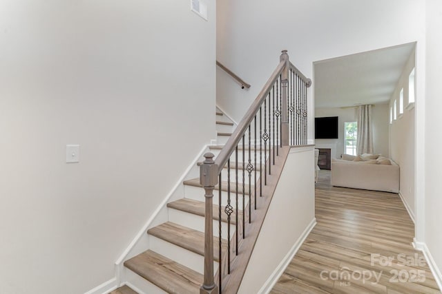 18026 Stark Way, Charlotte, NC 28278 - stairway featuring wood finished floors, baseboards, and a glass covered fireplace