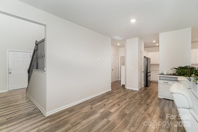 18026 Stark Way, Charlotte, NC 28278 - kitchen with freestanding refrigerator, light wood-style floors, recessed lighting, white cabinets, and baseboards