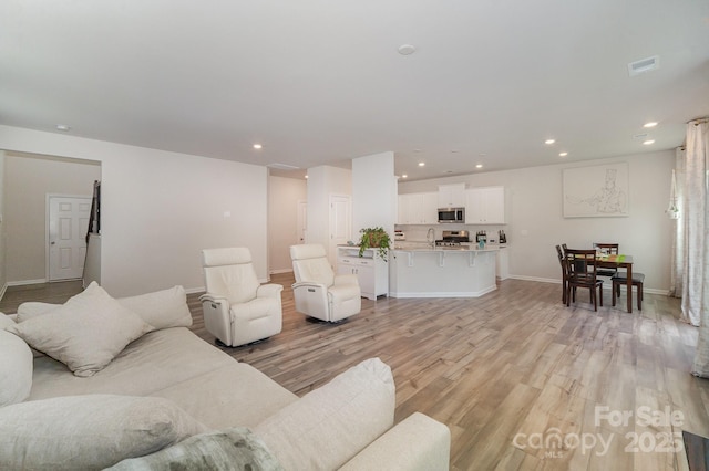 18026 Stark Way, Charlotte, NC 28278 - living room with recessed lighting, light wood-style flooring, and baseboards