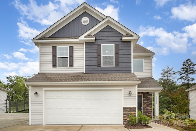 18026 Stark Way, Charlotte, NC 28278 - view of front of home with driveway, an attached garage, roof with shingles, and stone siding