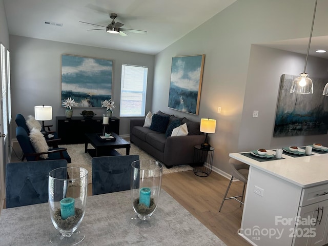1004 Johnson St, Charlotte, NC 28206 - living area featuring wood finished floors, lofted ceiling, a ceiling fan, and baseboards