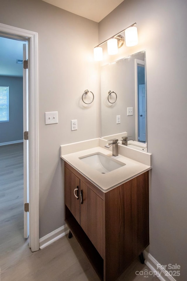 1004 Johnson St, Charlotte, NC 28206 - bathroom featuring vanity, baseboards, and wood finished floors