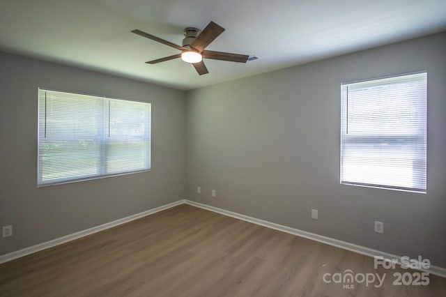 1004 Johnson St, Charlotte, NC 28206 - empty room with ceiling fan, wood finished floors, healthy amount of natural light, and baseboards