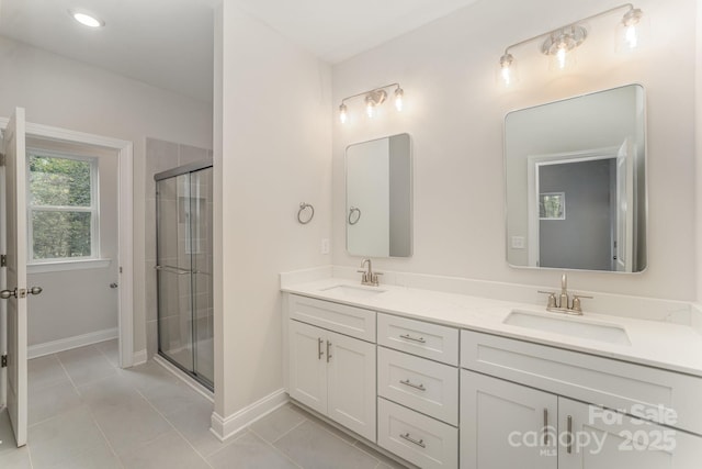 2818 Old Steele Creek Rd, Charlotte, NC 28208 - bathroom with a stall shower, double vanity, baseboards, and tile patterned floors