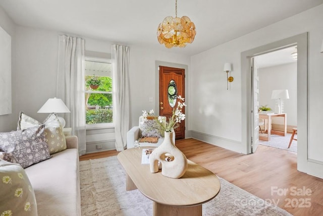 1000 Oakshade Ave, Kannapolis, NC 28083 - living room with light wood-type flooring, a chandelier, and baseboards