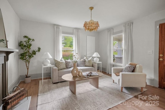 1000 Oakshade Ave, Kannapolis, NC 28083 - living area featuring healthy amount of natural light, wood finished floors, a chandelier, and baseboards