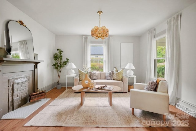 1000 Oakshade Ave, Kannapolis, NC 28083 - sitting room featuring a chandelier, plenty of natural light, wood finished floors, and a fireplace
