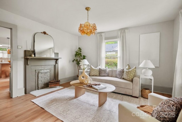 1000 Oakshade Ave, Kannapolis, NC 28083 - living area with wood finished floors, a fireplace, and a chandelier
