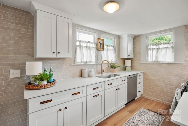 1000 Oakshade Ave, Kannapolis, NC 28083 - kitchen featuring stainless steel appliances, a sink, light countertops, light wood-style flooring, and white cabinetry