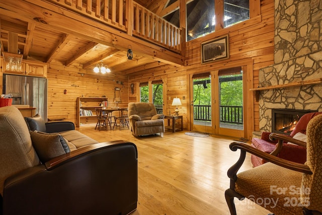 108 Cougar Aly Unit 79, Lake Lure, NC 28746 - living area with wood walls, wooden ceiling with exposed beams, wood finished floors, a chandelier, and a stone fireplace