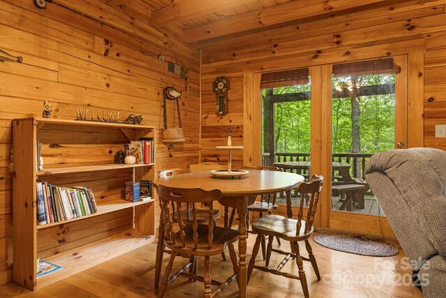 108 Cougar Aly Unit 79, Lake Lure, NC 28746 - dining space featuring wood walls, wood finished floors, and wooden ceiling with exposed beams