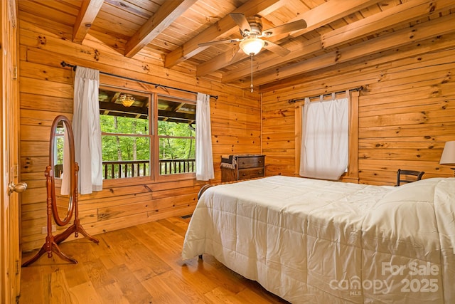 108 Cougar Aly Unit 79, Lake Lure, NC 28746 - bedroom with wood ceiling with exposed beams, wood walls, access to exterior, light wood-type flooring, and ceiling fan