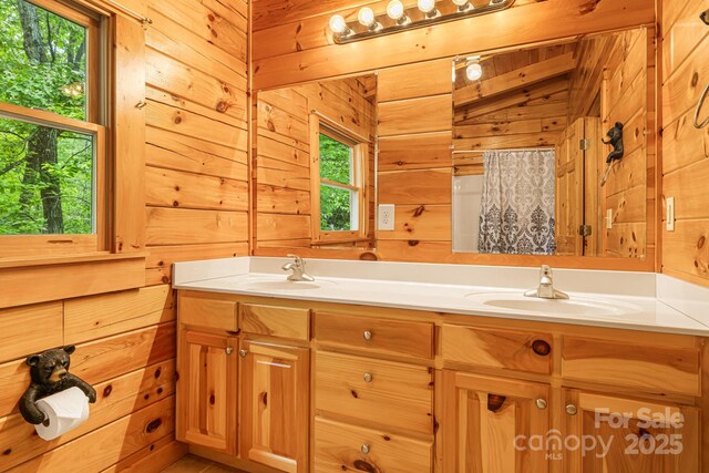 108 Cougar Aly Unit 79, Lake Lure, NC 28746 - bathroom featuring wooden walls, double vanity, and healthy amount of natural light
