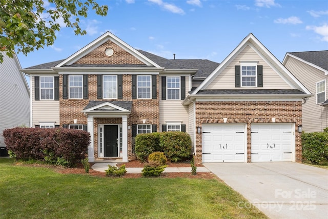 view of front of house with brick siding, driveway, a front yard, and a garage