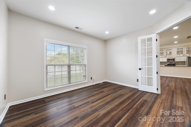 unfurnished room with dark wood-type flooring, french doors, baseboards, and recessed lighting