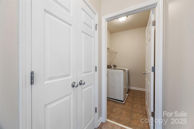 laundry room featuring washing machine and dryer, tile patterned floors, and baseboards