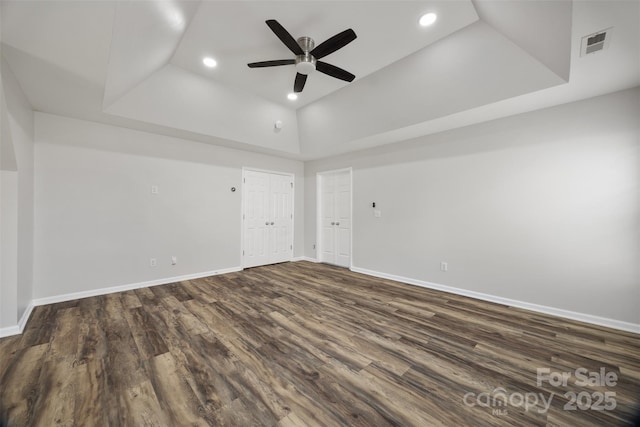 unfurnished room with a raised ceiling, ceiling fan, dark wood-style floors, baseboards, and recessed lighting