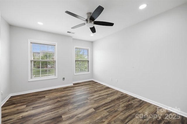 spare room with dark wood-style flooring, baseboards, recessed lighting, and ceiling fan