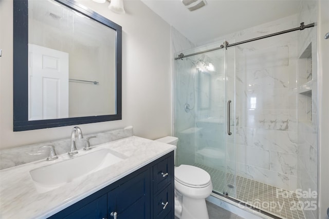 full bath featuring toilet, a marble finish shower, and vanity