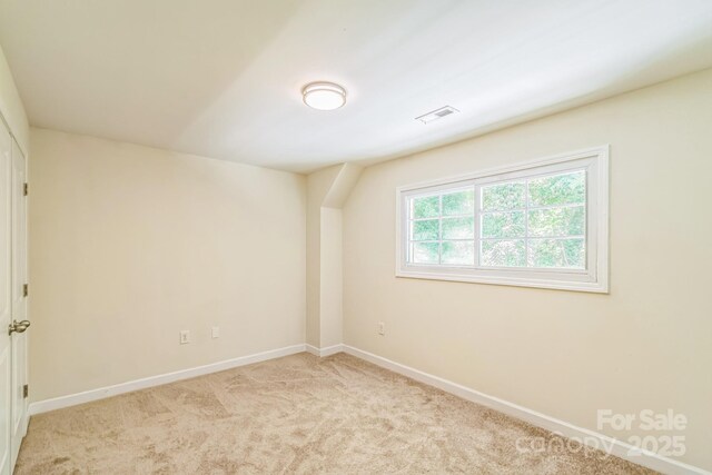 unfurnished room featuring baseboards and carpet flooring