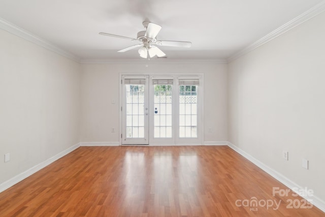 empty room featuring ceiling fan, light wood-type flooring, baseboards, and ornamental molding
