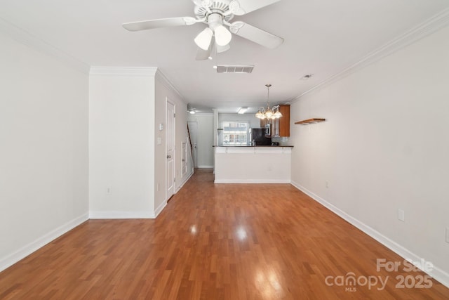unfurnished living room with a chandelier, ornamental molding, light wood finished floors, ceiling fan, and baseboards