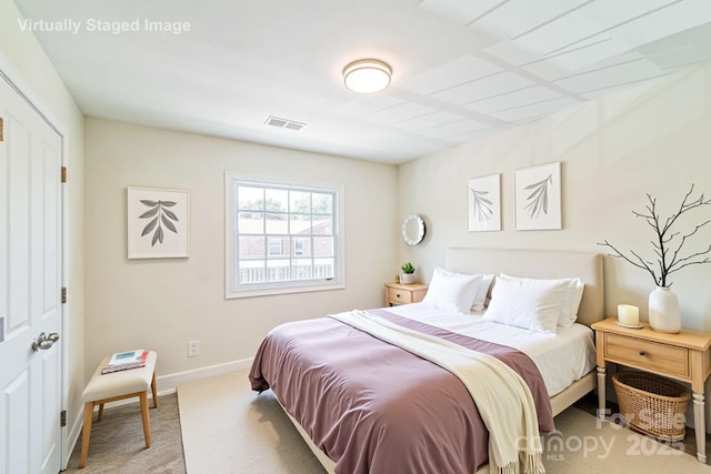bedroom featuring light colored carpet and baseboards