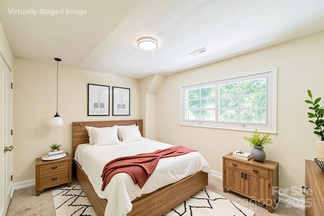 bedroom featuring baseboards and light carpet