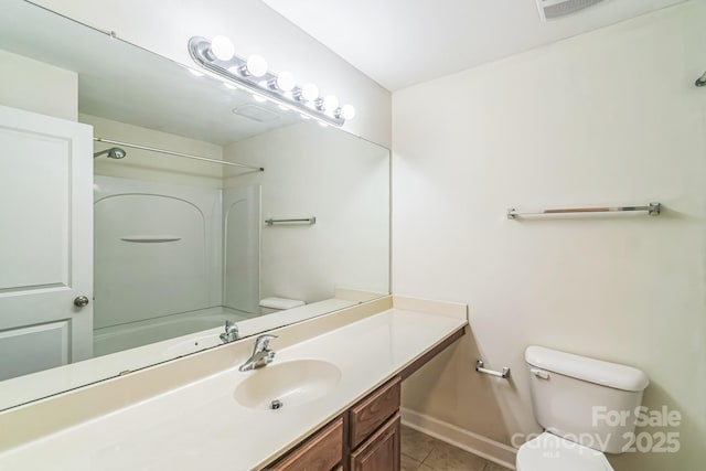 bathroom with toilet, tile patterned floors, vanity, and baseboards