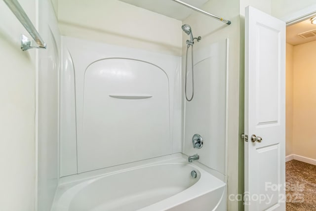 bathroom with shower / bathtub combination and baseboards
