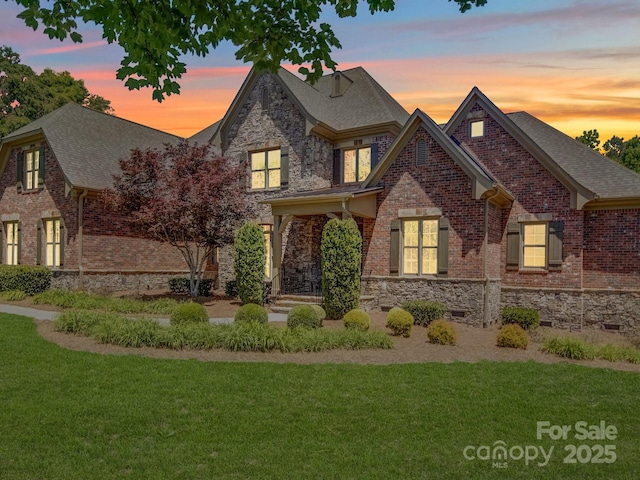 200 Waterby Way, Matthews, NC 28104 - view of front of house with a front lawn, brick siding, roof with shingles, and stone siding