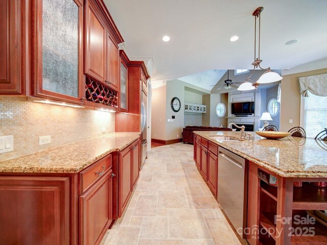 200 Waterby Way, Matthews, NC 28104 - kitchen featuring stainless steel appliances, a sink, baseboards, decorative backsplash, and light stone finish floors