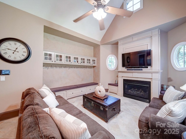 200 Waterby Way, Matthews, NC 28104 - living area with ceiling fan, high vaulted ceiling, a glass covered fireplace, light tile patterned flooring, and baseboards