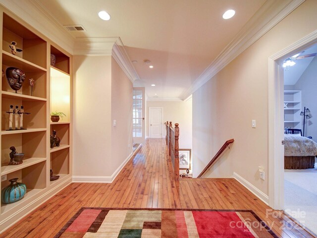 200 Waterby Way, Matthews, NC 28104 - hall with an upstairs landing, hardwood / wood-style floors, crown molding, baseboards, and built in shelves