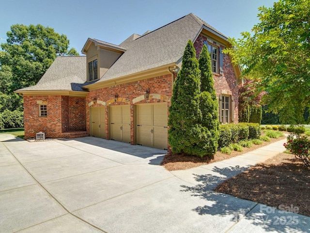 200 Waterby Way, Matthews, NC 28104 - view of side of property featuring driveway, brick siding, a shingled roof, and a garage