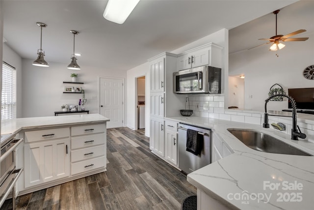 1140 Landsdown Dr, Salisbury, NC 28147 - kitchen with stainless steel appliances, a sink, backsplash, ceiling fan, and dark wood-style floors