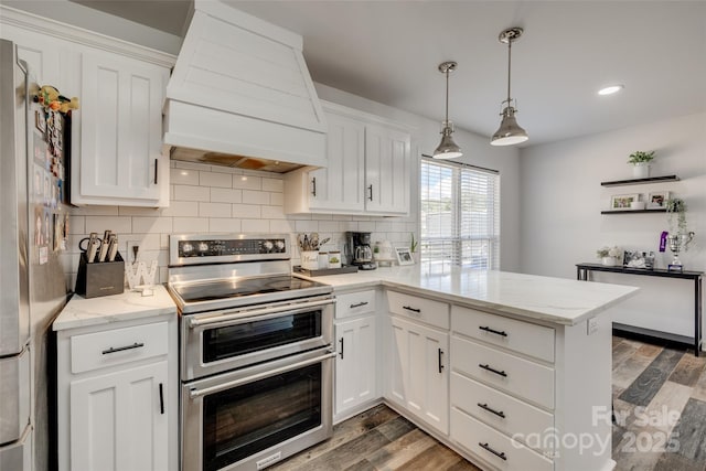 1140 Landsdown Dr, Salisbury, NC 28147 - kitchen with appliances with stainless steel finishes, premium range hood, wood finished floors, decorative backsplash, and recessed lighting