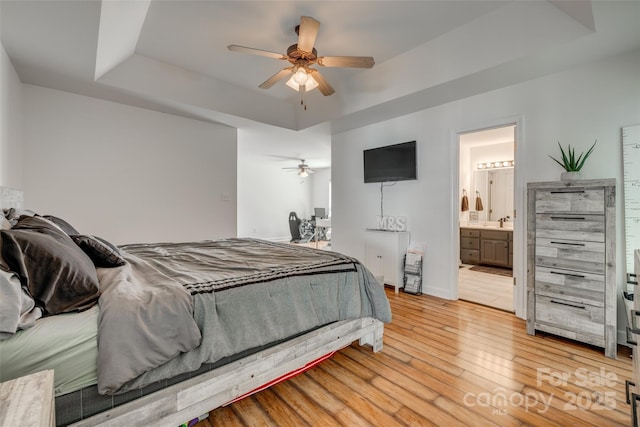 1140 Landsdown Dr, Salisbury, NC 28147 - bedroom with a tray ceiling, light wood-type flooring, ceiling fan, and connected bathroom