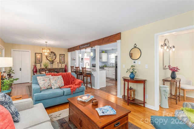307 Tree Haven Blvd, Hendersonville, NC 28791 - living room with a chandelier and light wood-style flooring
