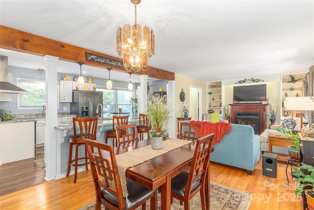 307 Tree Haven Blvd, Hendersonville, NC 28791 - dining space featuring plenty of natural light, light wood-style flooring, and a glass covered fireplace