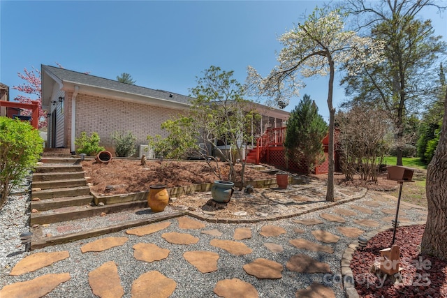 307 Tree Haven Blvd, Hendersonville, NC 28791 - rear view of house featuring stairway, brick siding, and a wooden deck