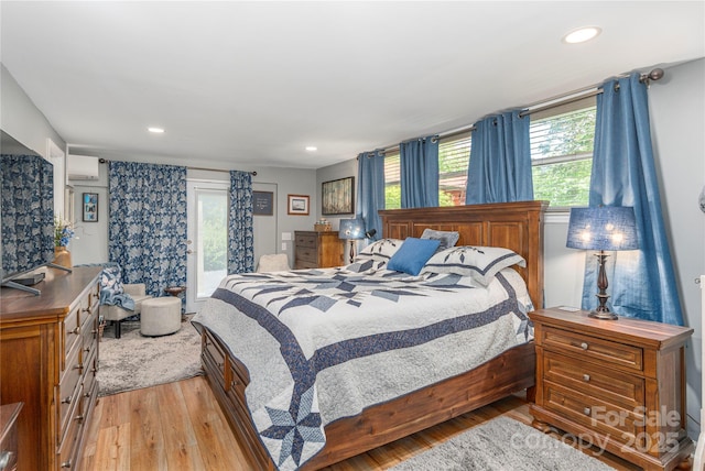 307 Tree Haven Blvd, Hendersonville, NC 28791 - bedroom featuring light wood-style floors, access to outside, a wall mounted AC, and recessed lighting