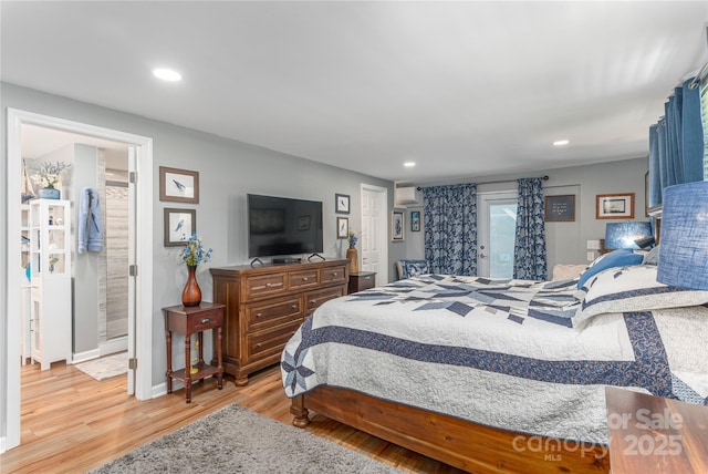 307 Tree Haven Blvd, Hendersonville, NC 28791 - bedroom with wood finished floors, recessed lighting, baseboards, a wall unit AC, and ensuite bath