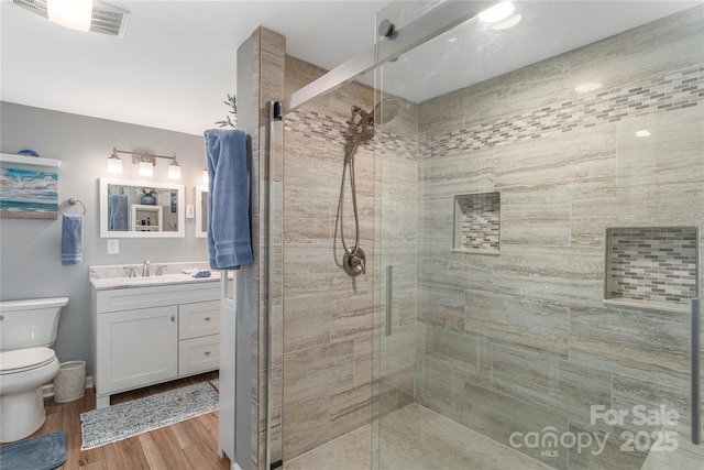 307 Tree Haven Blvd, Hendersonville, NC 28791 - bathroom with toilet, a shower stall, vanity, and wood finished floors