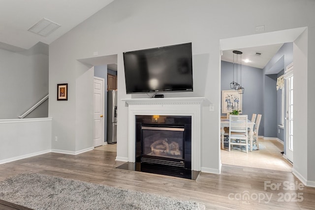 3820 Leela Palace Way, Fort Mill, SC 29708 - living area with a fireplace with flush hearth, wood finished floors, high vaulted ceiling, and baseboards