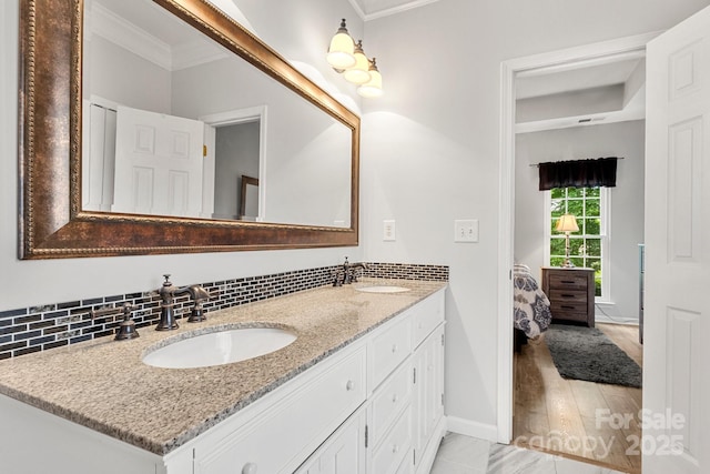 3820 Leela Palace Way, Fort Mill, SC 29708 - ensuite bathroom featuring ornamental molding, baseboards, double vanity, wood finished floors, and tasteful backsplash