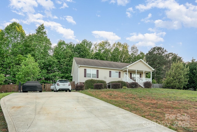 1221 Woodpecker Dr, Clover, SC 29710 - ranch-style home with a porch, concrete driveway, roof with shingles, and view of scattered trees