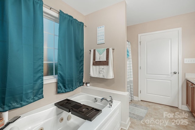 1221 Woodpecker Dr, Clover, SC 29710 - bathroom with a jetted tub, vanity, tile patterned floors, and baseboards